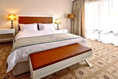 a bedroom with a large bed and a window at Primoretz Grand Hotel & Spa in Burgas City