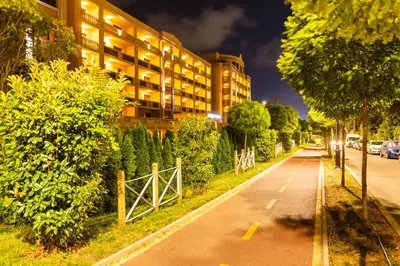 an empty street in front of a building at night at Primoretz Grand Hotel & Spa in Burgas City
