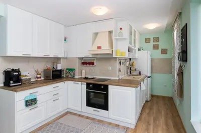 a kitchen with white cabinets and white appliances at Soulful Apartments - Horizon in Varna City