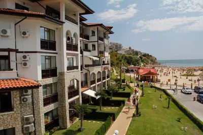 a view of a building and a street with people at Arena 65m2 - 1 bedroom, 1st line to the beach in Sveti Vlas