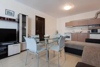 a living room with a glass table and chairs at Arena 65m2 - 1 bedroom, 1st line to the beach in Sveti Vlas