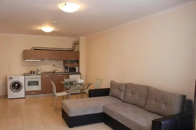 a living room with a couch and a kitchen at Arena 65m2 - 1 bedroom, 1st line to the beach in Sveti Vlas