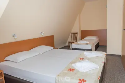 a bedroom with two beds with towels on them at Hotel Eva in Ravda