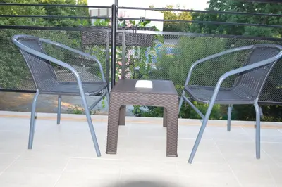 two chairs and a table on a patio at Villa Valentines in Kiten
