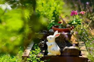 a statue of a bunny sitting next to a potted plant at Villa Yanevi in Lozenets