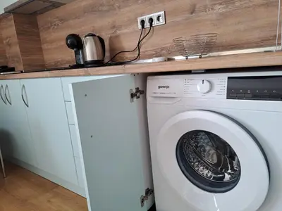 a washing machine in a kitchen with a counter at Hotel City in Burgas City