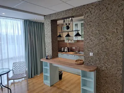a kitchen with a island in the middle of a room at Hotel City in Burgas City