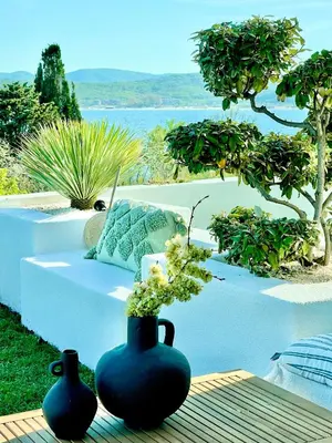 two blue vases sitting on a bench next to a table at Casa de oro Alma in Sozopol