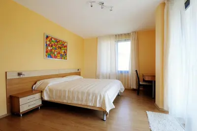 a bedroom with a bed and a desk in it at Guest House Daris in Sozopol