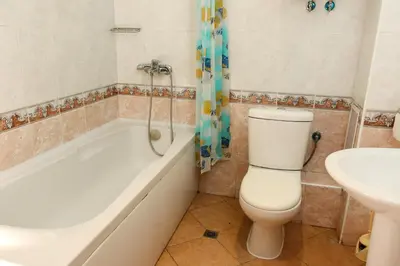 a bathroom with a toilet and a tub and a sink at Complex Sozopol Dreams BMT in Sozopol