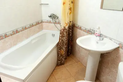 a bathroom with a tub and a sink at Complex Sozopol Dreams BMT in Sozopol