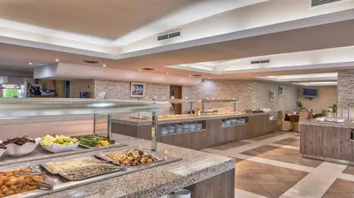 a cafeteria with a buffet line with food at Hotel Golden Dune in Sunny Beach