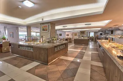 a large room with a bar in a restaurant at Hotel Golden Dune in Sunny Beach