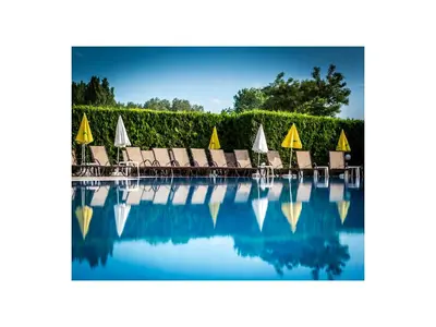 a group of chairs and a swimming pool at Hotel Golden Dune in Sunny Beach