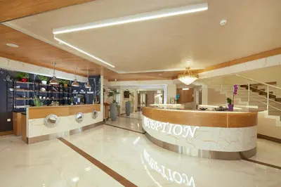 a large lobby with a reception desk and a pharmacy at Hotel Golden Dune in Sunny Beach