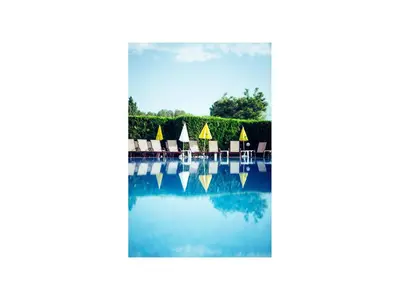 a view of a pool of water with chairs at Hotel Golden Dune in Sunny Beach