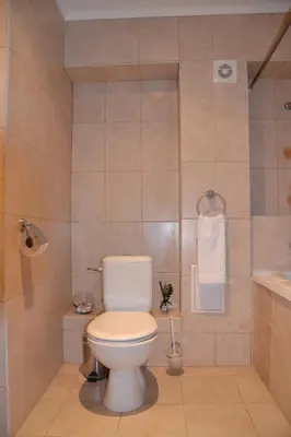 a bathroom with a toilet and a sink at Apartment on the Cliff Obzor in Obzor