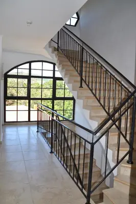 a staircase in a house with a large window at Apartment on the Cliff Obzor in Obzor