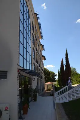 a building with glass windows on the side of it at Apartment on the Cliff Obzor in Obzor