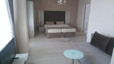 a living room with a bed and a couch at Guest House Adriya in Primorsko