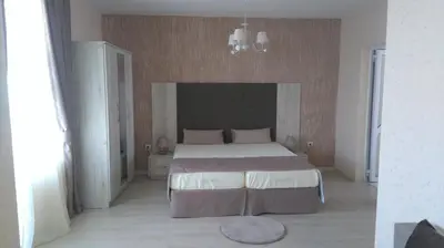 a bedroom with a large bed in a room at Guest House Adriya in Primorsko