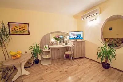 a room with a vanity and a table with plants at Hotel Color in Varna City