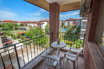 a balcony with a table and chairs and a view at Apollon Apartments in Nesebar