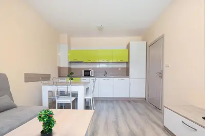 a kitchen and living room with a couch and a table at Apollon Apartments in Nesebar
