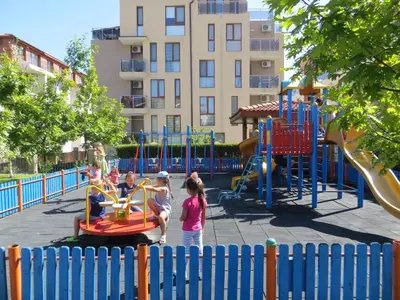 a group of children playing in a playground at Apollon Apartments in Nesebar