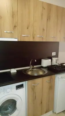a kitchen with a sink and a washing machine at Apartments in Casa del Sol in Sunny Beach