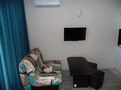 a living room with a couch and a chair and a television at Apartments in Casa del Sol in Sunny Beach