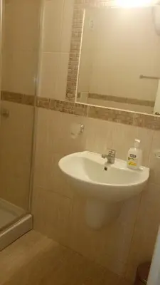 a bathroom with a sink and a shower with a mirror at Apartments in Casa del Sol in Sunny Beach