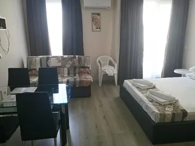 a bedroom with two beds and a table and a chair at Apartments in Casa del Sol in Sunny Beach