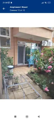 a picture of a house with a patio with flowers at Apartament Janet in Pomorie