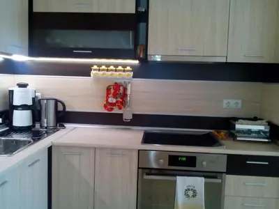 a kitchen with a stove and a microwave at Byala Relax Apartments in Byala