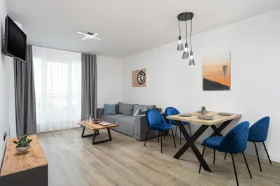 a living room with a couch and a table at Семеен хотел Golden Place in Sozopol