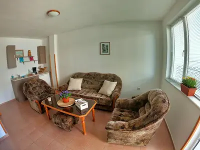 a living room with two chairs and a couch and a table at Apartment in St. Vlas with terrace in Sveti Vlas