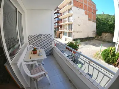 a balcony with a table and chairs on a building at Apartment in St. Vlas with terrace in Sveti Vlas