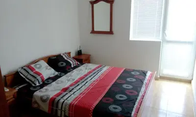 a bedroom with a bed with a colorful blanket on it at Bravo 5 Sunny Beach in Sunny Beach