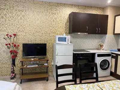 a kitchen with a stove and a microwave at Belchevi Apartments in Burgas City