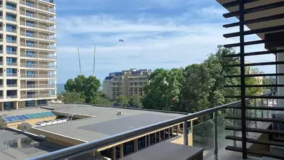 a kite is flying over a building on a balcony at Bratanov Asteria Family in Sunny Beach