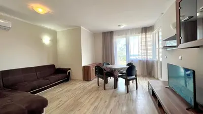a living room with a couch and a table at Bratanov Asteria Family in Sunny Beach