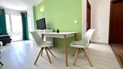 a living room with a table and two chairs at Bratanov Asteria Family in Sunny Beach