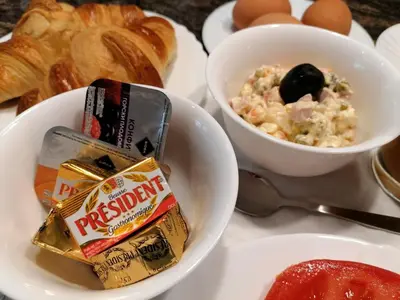a plate with two bowls of breakfast food and croissants at City Boutique Inn in Varna City