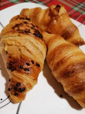 a white plate with three croissants on a table at City Boutique Inn in Varna City