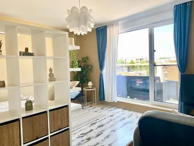 a living room with white shelves and a large window at Apartments in Complex Sunny Island Deluxe in Chernomorets