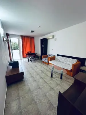 a living room with two beds and a table at Stella Udacha Apartments & Studios in Sunny Beach