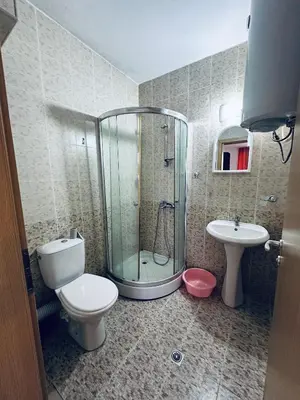 a bathroom with a shower and a toilet and a sink at Stella Udacha Apartments & Studios in Sunny Beach