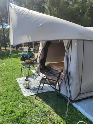 a tent with a table and a chair in the grass at Ecoclub in Varna City