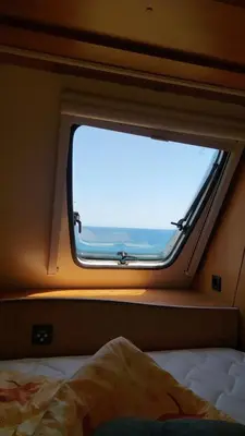 a window in an airplane with a view of the ocean at Ecoclub in Varna City
